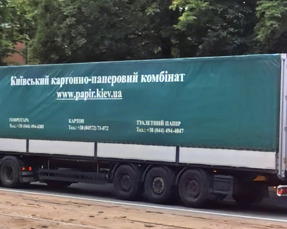 Historical 2025 view of the KKPK company name on a truck trailer in Dnipro; not the Obukhiv mill or the October 2026 strike scene
