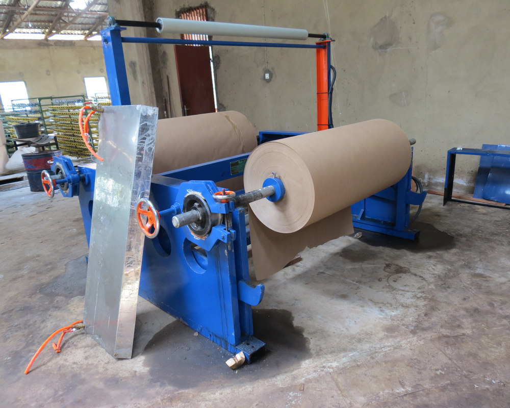 Documentary photo of paper rolls at an unrelated box-production facility, not the advertised classroom