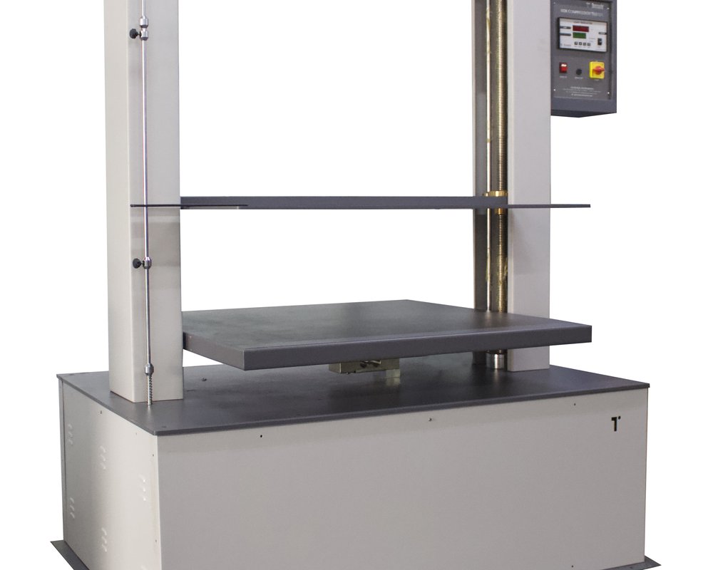 Reference photo of an empty box-compression tester, not a returned-carton experiment or measured residual-strength result